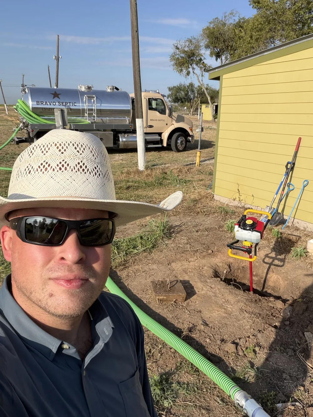 Bravo Septic on a job with the pump truck parked behind