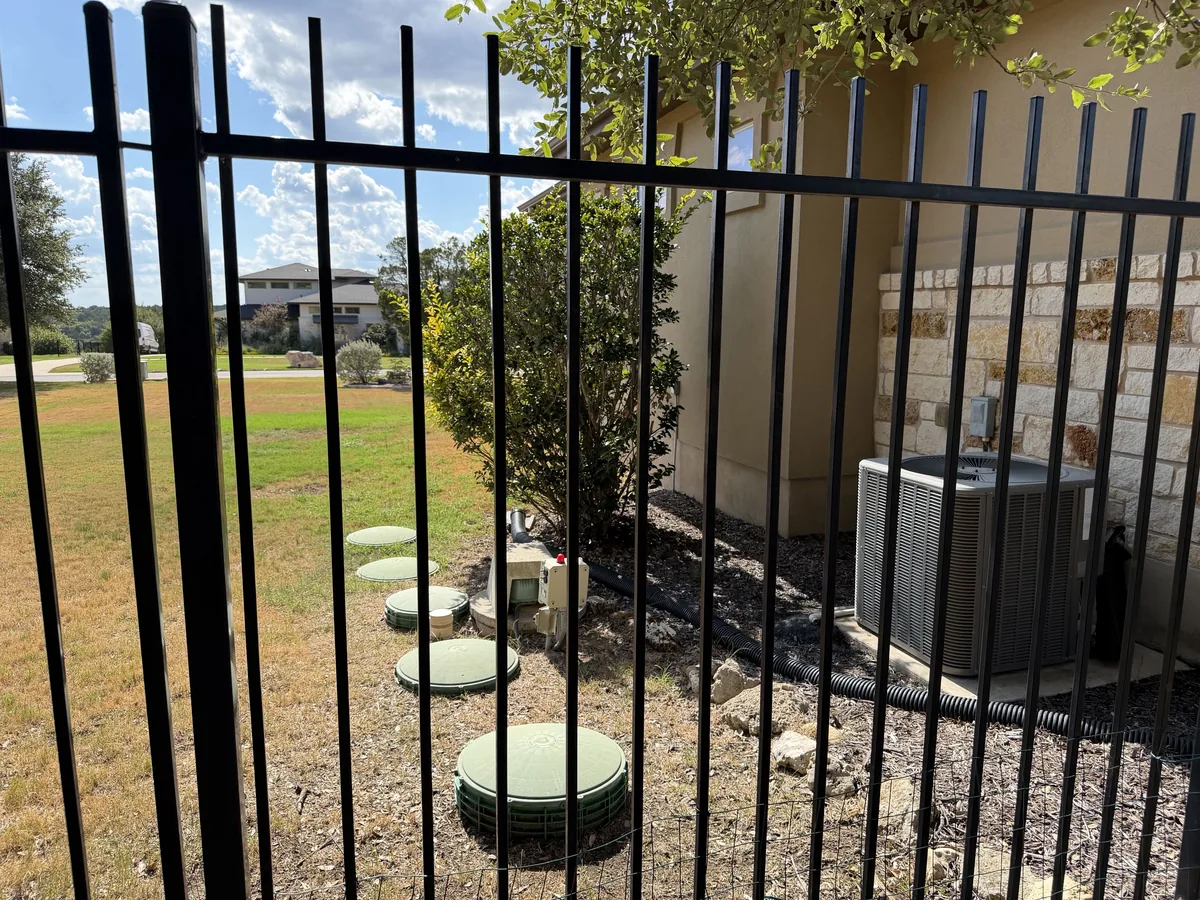 Green septic lids in the yard of a single-family home in Central Texas